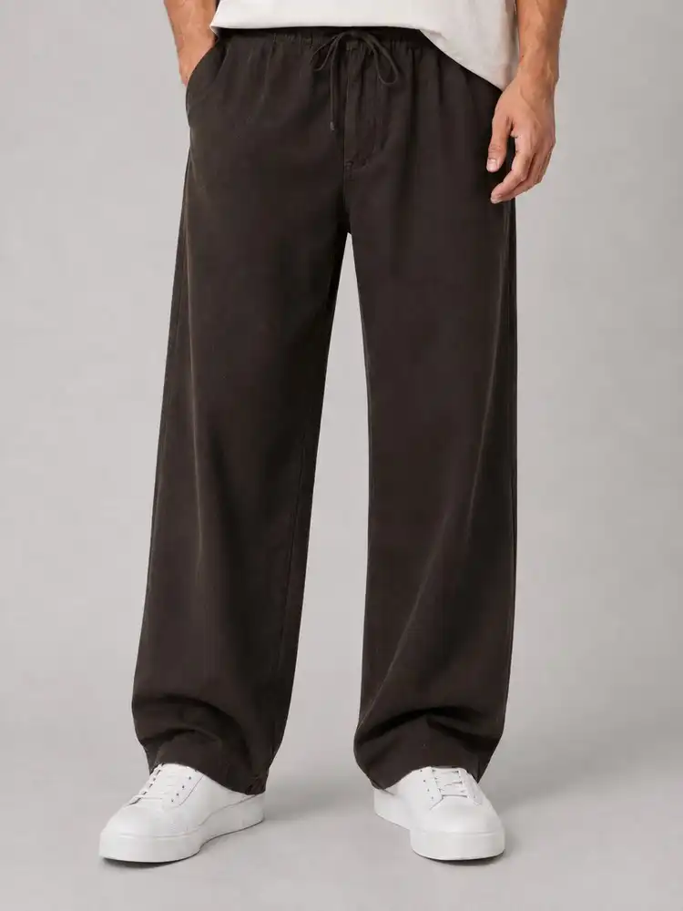 Natural-Lyocell-fabric-half-bag-pants-long-length-108-brown-color-heroshoop.webp شلوار پارچه ای نیم بگ پارچه لایوسل طبیعی / قد بلند ۱۰۸ / رنگ قهوه ای ساده - Image 1