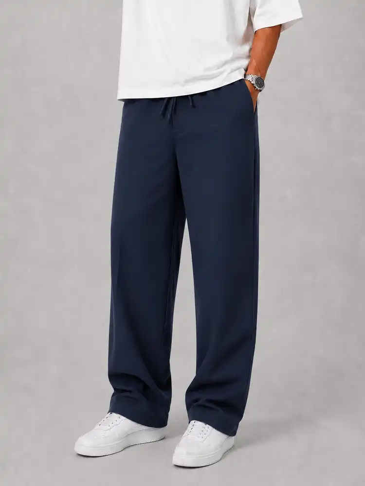Natural-Lyocell-fabric-half-bag-pants-long-length-108-navy-color-heroshoop-view1.webp شلوار پارچه ای نیم بگ پارچه لایوسل طبیعی / قد بلند ۱۰۸ / رنگ سرمه ای ساده - Image 1